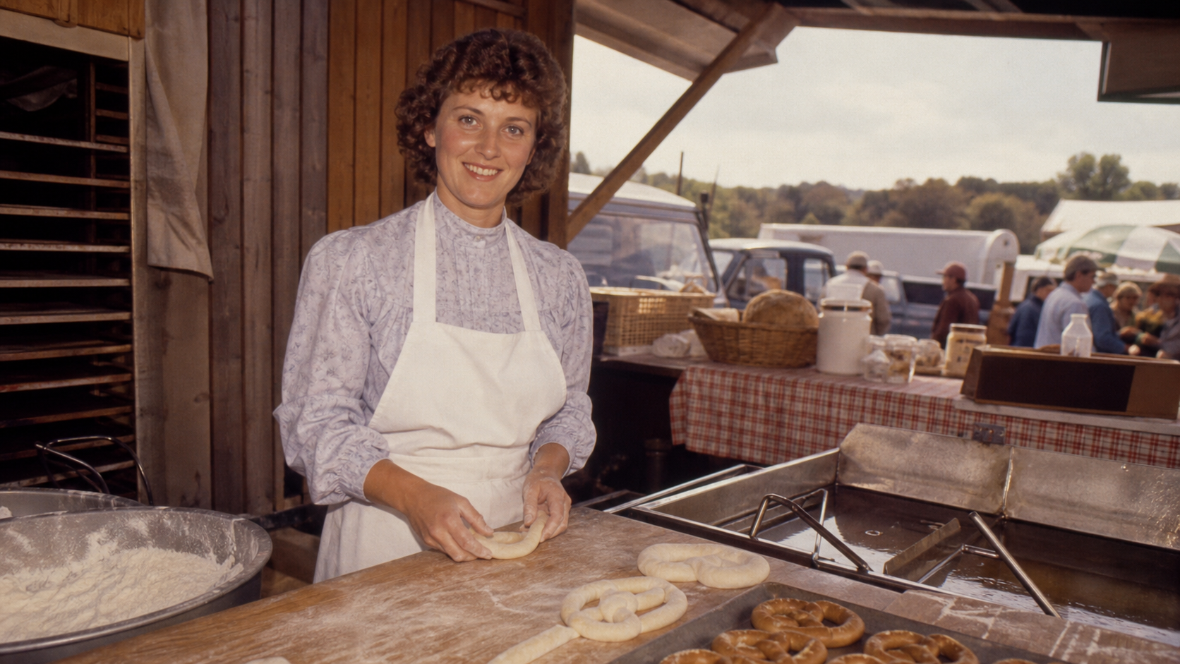 Anne Beiler working at a modest 1988 Pennsylvania farmers market pretzel stand with hand-rolled dough